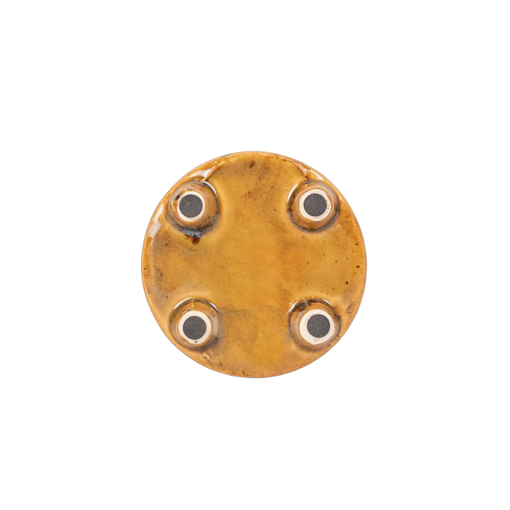 The Foreside Home & Garden Glossy Brown Ceramic Planter Pot features a shiny amber-brown reactive glaze and four small pads near the edge, shown from above against a white background.