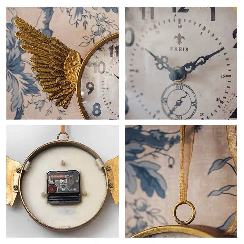 A collage features the IRON CLOCK IN GOLD FINISH by Vagabond Vintage, with golden angel wings, floral background, ornate hands, Paris label, battery compartment back, and hanging loop.