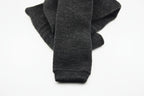 A pair of dark gray, folded Choice Alpaca Products Alpaca Leggings is displayed on a plain white background, known for their temperature regulating and moisture wicking properties.