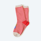 The Clayton Sock by Hooray Sock Co. is a pair of red and white striped crew socks with cream toes, heels, and cuffs, plus a small blue and yellow rectangle patch near the ankle, displayed on a light background.