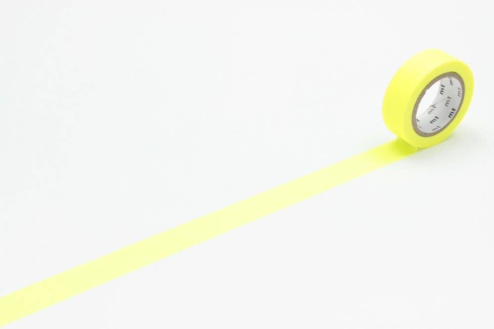 A roll of mt masking tape (Sweet Bella) in Shocking Yellow, with a strip unrolled across a white surface.