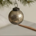 The 2" SILVER CRACKLE KUGEL BLING by Ragon House adds vintage charm to any tree, its antique silver finish reflecting light for an elegant holiday decoration.