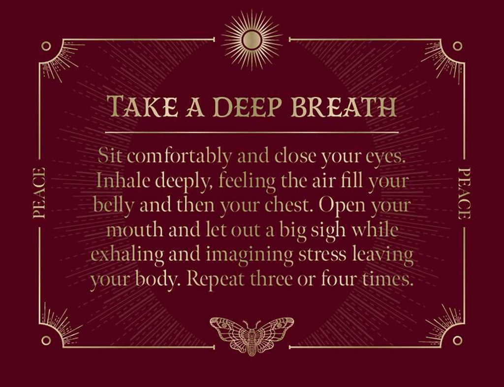 The maroon card with gold accents from Spells: A Little Deck of Enchantments by Lorriane Anderson (Simon & Schuster) reads: “Take a Deep Breath. Sit comfortably and close your eyes. Inhale deeply… Let out a big sigh as you exhale, releasing stress and inviting witchy inspiration into your day. Repeat three or four times.”.