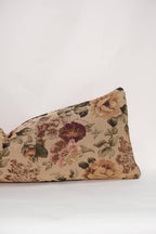 The Tapestry Long Lumbar by Twenty Third by Deanne is a rectangular reversible pillow featuring a vintage floral pattern in beige, pink, green, and burgundy on a plain white background.