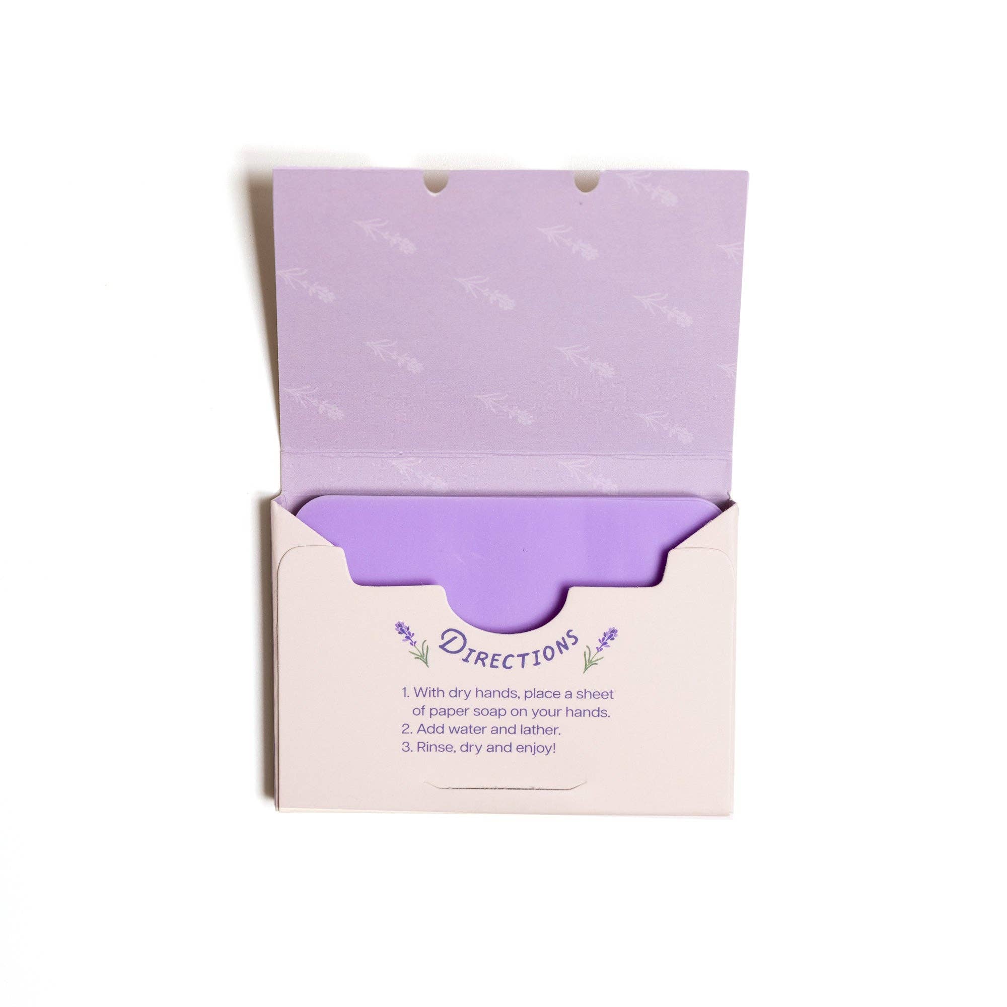 The 123 Farm Paper Soap – Lavender Scent, Travel Size (50 Sheets) features a light purple packet with lavender designs and directions inside the lid, showing a fragrant stack of cleansing soap sheets on a white background.