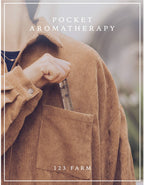 A person wearing a brown corduroy shirt places a Lavender Tranquil Roller – Organic Blend for Relaxation 10ml by 123 Farm into their chest pocket. Text on the image reads “Pocket Aromatherapy” and “123 Farm.”.
