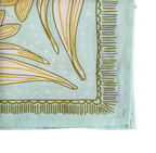 Close-up of the No. 012 Eliza Bandana by Handker Bandanas, featuring a light blue floral design with green and yellow abstract patterns, decorative border, visible edge stitching, and hand screen-printed on premium cotton.