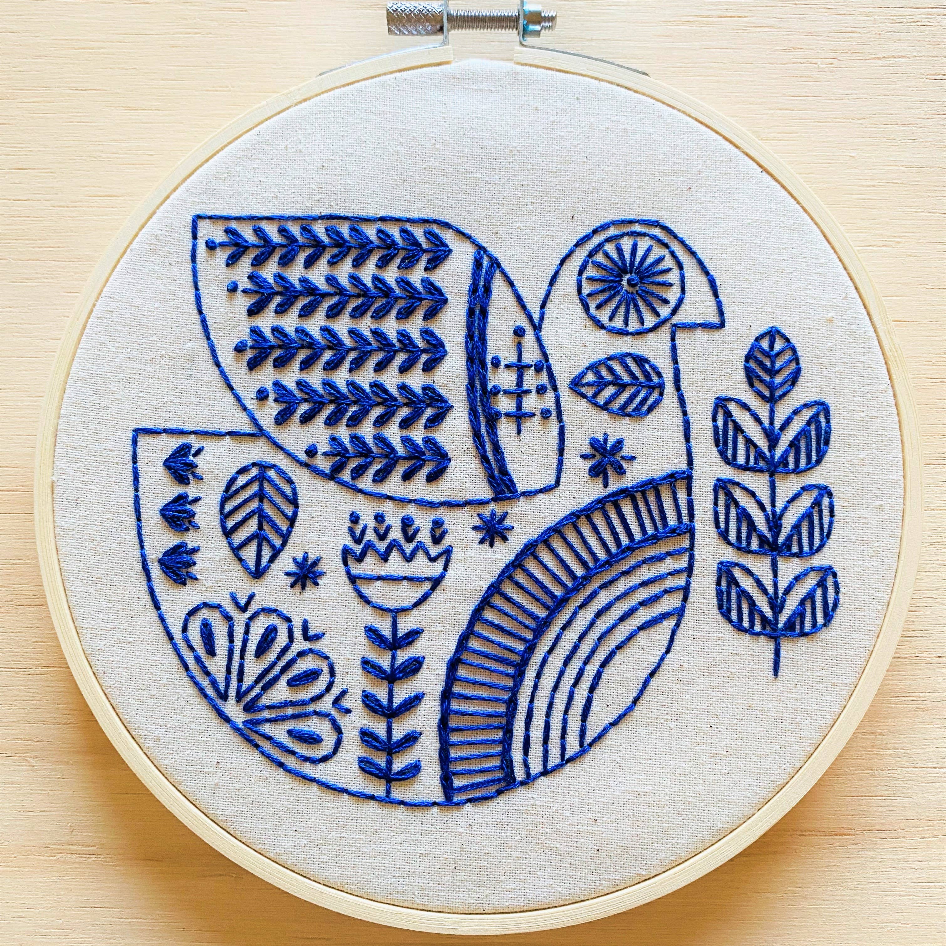 The Hygge Dove Complete Embroidery Kit by Hook, Line & Tinker features a charming blue and white bird—ideal for crafters of any level.