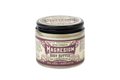 A glass jar of Roots And Leaves Magnesium Body Butter features extra strength, unrefined shea, cocoa, and mango butters for optimal magnesium absorption. The purple and cream labels on the lid and front are clearly visible.