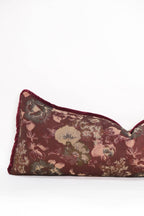The Tapestry Long Lumbar by Twenty Third by Deanne is a rectangular pillow featuring a burgundy botanical tapestry design with tan, green, and pink florals on a plain white background.