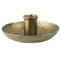 The HomArt Tanta Taper Holder is a brass-plated aluminum candle holder with a round base and central cylindrical holder, designed for a single candle.