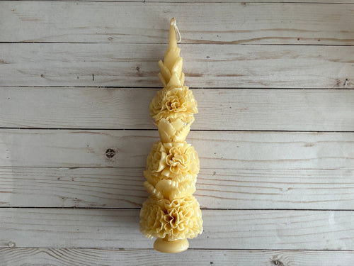Ivory Large Floral Oaxaca Marigold Day of the Dead Candle: a tall, tapered ivory beeswax candle sculpted with stacked marigold flowers in the style of traditional Oaxaca candles.