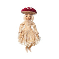 The C&F Home Myra Mushroom Gathered Traditions Art Doll features a sad expression, vintage lace dress, large red mushroom cap hat, light hair, and elongated limbs, perfect for unique décor.