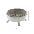 The HomArt Ceramic Rue Footed Soap Dish - Fancy White features three short legs, a scalloped edge, and a raised platform with holes. Measuring 4" wide by 2" tall, it's a charming bathroom accessory for any space.