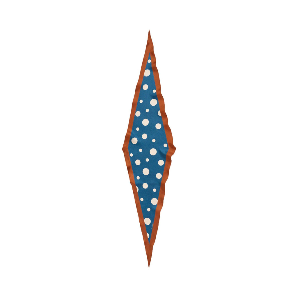 The Lost Pattern NYC Silk Polka Dot Diamond Neckerchief - Salted Caramel features a long diamond shape with an agate grey border, wavy brown edges, and a blue center adorned with white polka dots in various sizes.