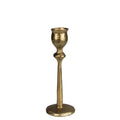 The HomArt Sonrisa Taper Holder, Brass - Sm, is a single fluted metal candlestick holder with a textured surface and wide round base, shown upright on a white background.