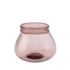 The Indaba Trading Recycled Glass Vase, Sangria, features a round, wide-mouthed hand-blown design in light mauve with textured air bubble glass and a flared opening for a modern decorative touch.
