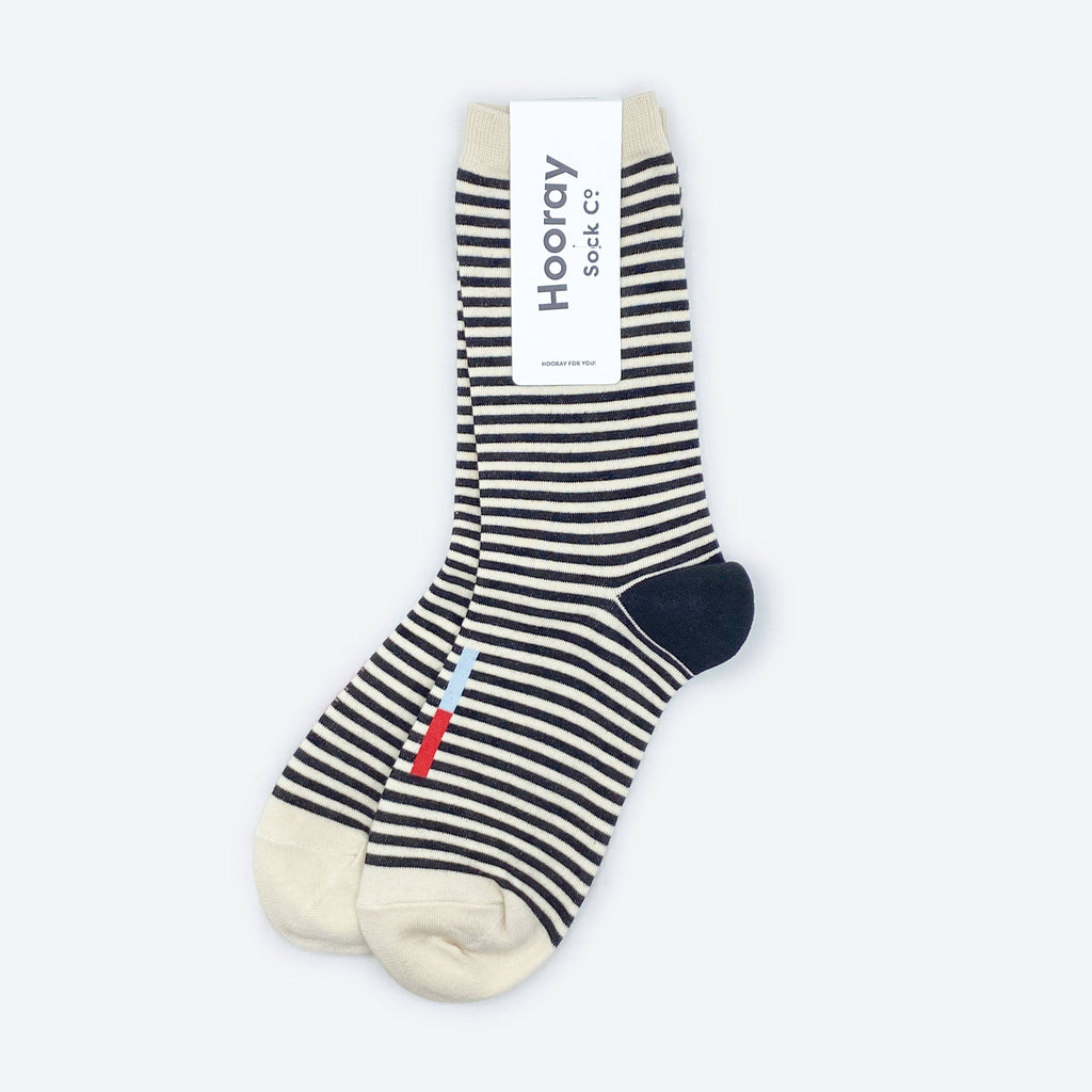 The Cole Black and White Striped Crew Socks by Hooray Sock Co. offer unisex comfort and everyday style.