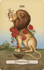 A lion adorned with red roses around its neck sits serenely as a woman’s hand, holding a cup, ties a red ribbon to its mane—an image that reflects the gentle artistry of Jessica Roux in her nature-inspired Tarot of the Woodland Wardens (Simon & Schuster; Mixed Media; 224 pages / English). In the background rises a mountain, capturing the earthy beauty characteristic of this tarot deck. The card is marked VIII and Strength.