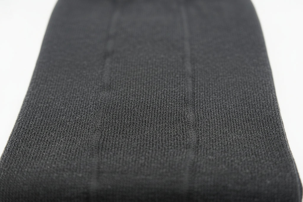 Close-up of a black ribbed knit fabric set against a white background—perfect for Choice Alpaca Products' Alpaca Leggings, prized for their temperature regulation and moisture wicking qualities.