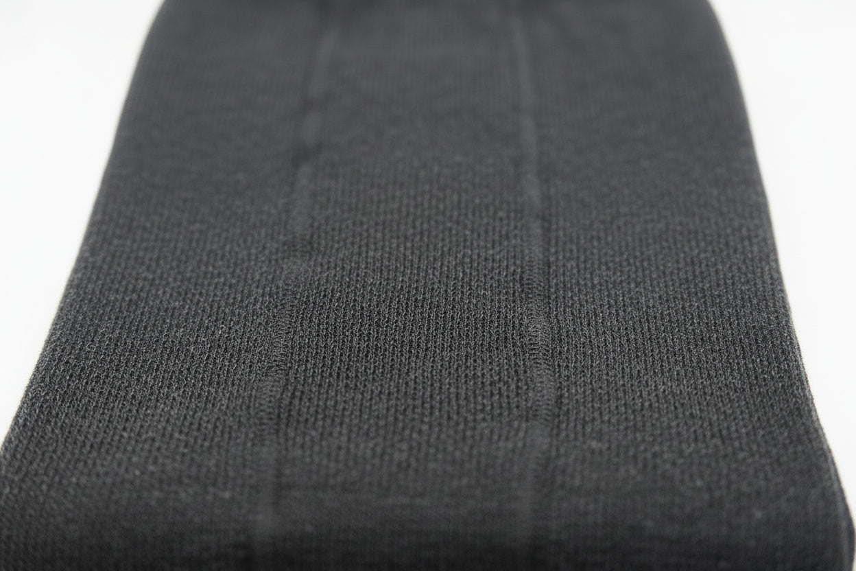 Close-up of a black ribbed knit fabric set against a white background—perfect for Choice Alpaca Products' Alpaca Leggings, prized for their temperature regulation and moisture wicking qualities.