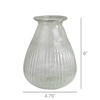 The HomArt Peppered Vase features a wide bottom, flared rim, and vertical ribbing in seeded recycled glass. This vase stands 6" tall and measures 4.75" wide at its widest point.