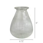 The HomArt Peppered Vase features a wide bottom, flared rim, and vertical ribbing in seeded recycled glass. This vase stands 6" tall and measures 4.75" wide at its widest point.