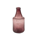 The Indaba Trading Recycled Glass Bottle Vase in mauve features a narrow neck, wide base, and textured wavy lower half. Made from recycled glass, this vintage-inspired vase adds style with its unique shape and eco-friendly design.