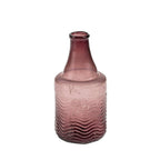 The Indaba Trading Recycled Glass Bottle Vase in mauve features a narrow neck, wide base, and textured wavy lower half. Made from recycled glass, this vintage-inspired vase adds style with its unique shape and eco-friendly design.