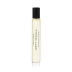 The DIRTY VANILLA ROLLERBALL: 10ML by Heretic Parfum is a clear glass perfume bottle with a black cap, labeled “DIRTY VANILLA,” shown on a white background and featuring warm sandalwood and rich amber notes.