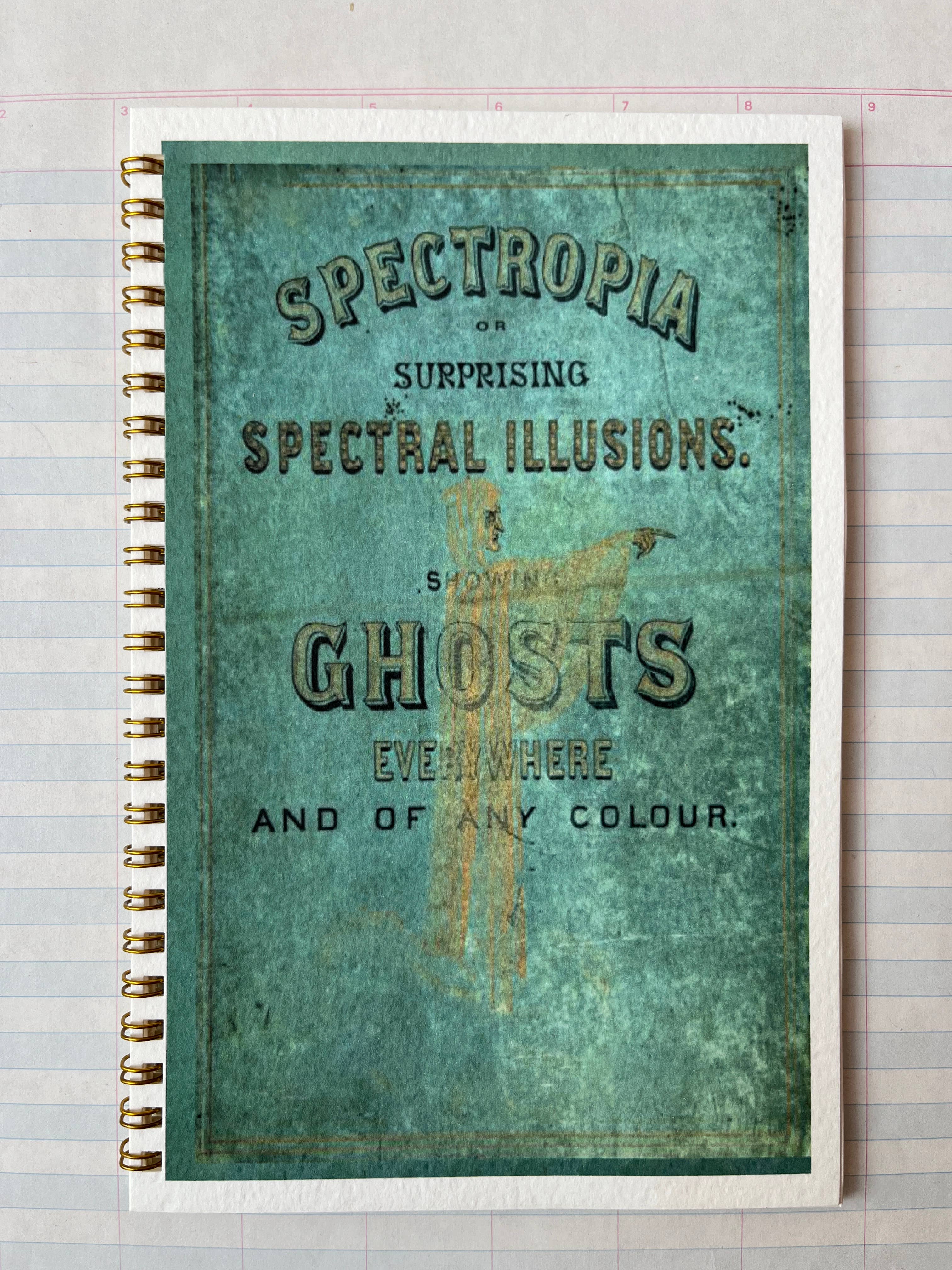 The Parcel "Spectropia, Spectral Illusions and Ghosts" journal has lined pages and a vintage-style cover mimicking an old book, set on turquoise with a worn texture—ideal for fans of textured watercolor notebooks and ghostly motifs.