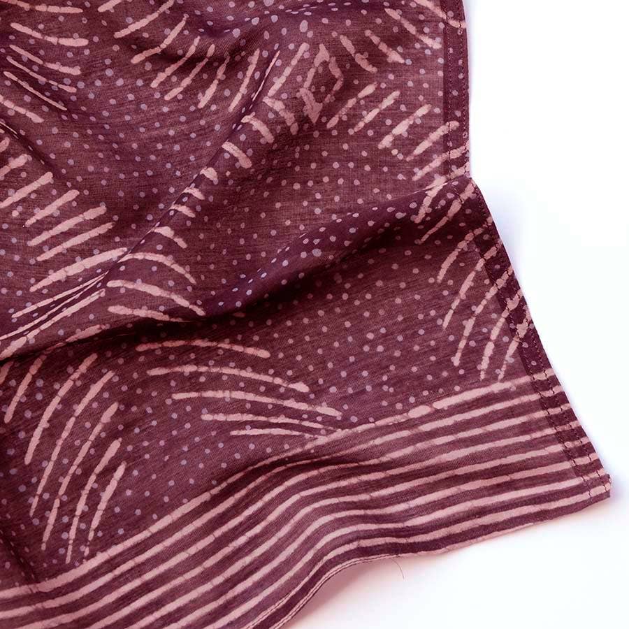 The Ichcha Square Bandana Scarf in violet features artisan hand block prints with light pink abstract dots, curves, and horizontal stripes along the edge, displayed on a white background.