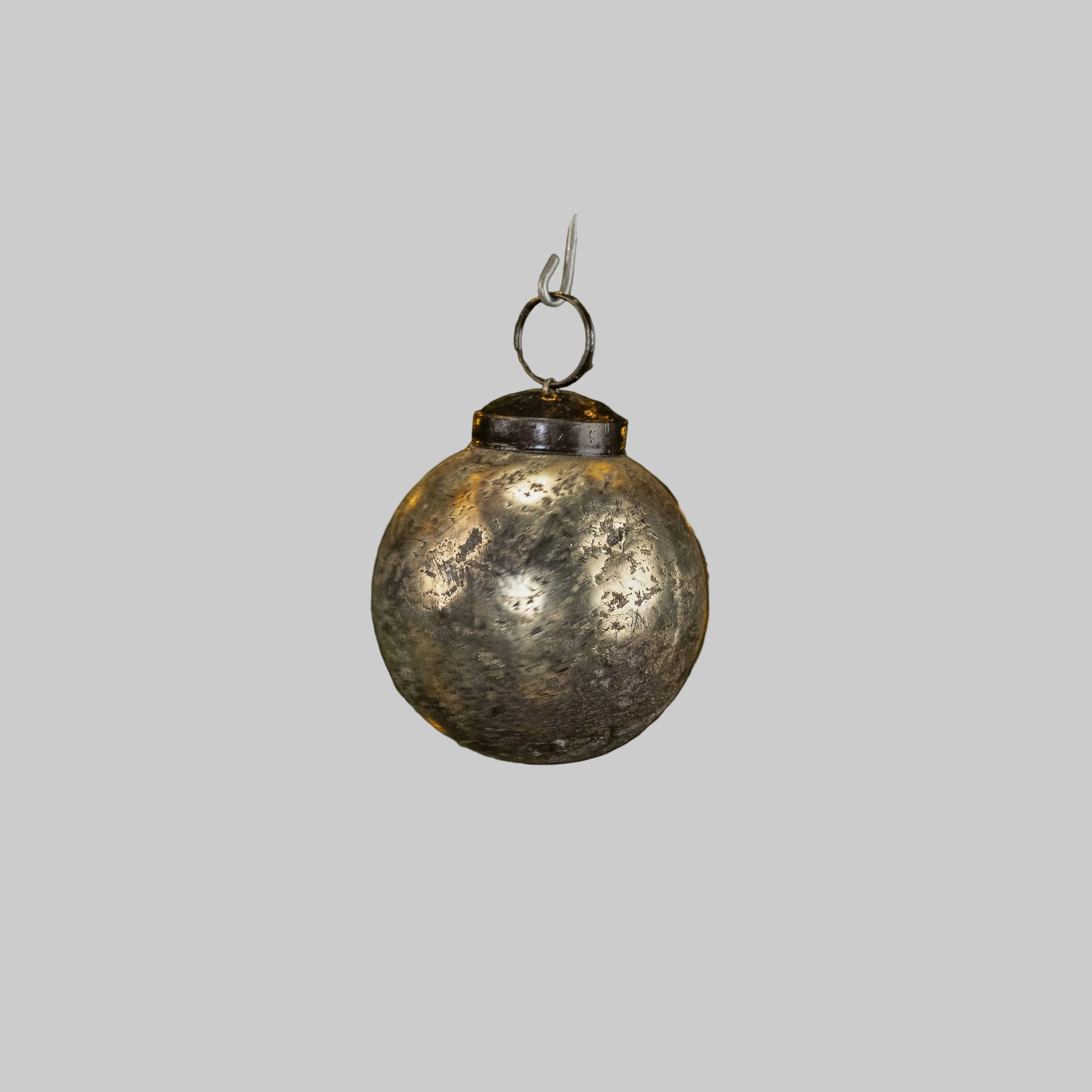 A 2" SILVER CRACKLE KUGEL BLING ornament by Ragon House, featuring a slightly tarnished, textured surface, hangs against a plain light gray background.
