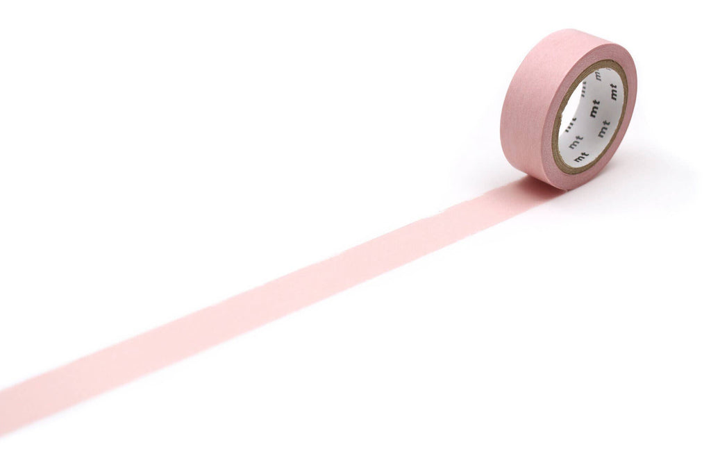 A roll of Pastel Scarlet mt masking tape with a strip pulled out against a white background.
