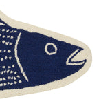 A close-up of the Striper Shaped Hook Rug by Kate Nelligan for Peking Handicraft, a blue and white wool fish-shaped rug featuring a minimal design with its head, open mouth, and body—ideal as an entryway accent.