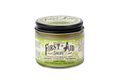 The Roots And Leaves First Aid Salve is an organic, petroleum-free ointment in a small glass jar with a black lid. It blends comfrey, calendula, manuka honey, and more natural ingredients, as highlighted on its decorative label.