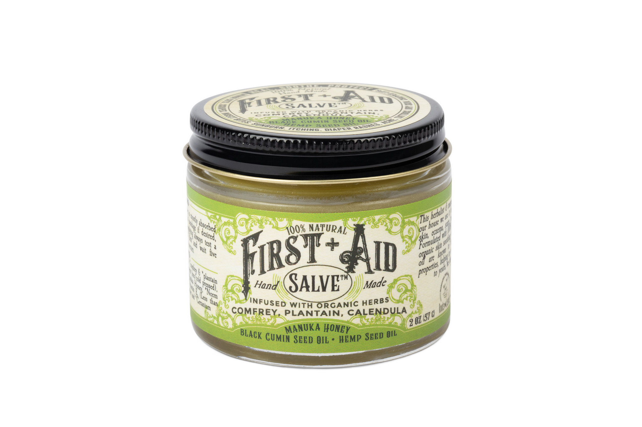 The Roots And Leaves First Aid Salve is an organic, petroleum-free ointment in a small glass jar with a black lid. It blends comfrey, calendula, manuka honey, and more natural ingredients, as highlighted on its decorative label.
