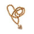 The Indaba Trading Wooden Heart Prayer Beads Large features round wooden beads and a heart-shaped pendant, arranged in a loose loop on a white background—perfect for meditation or as decorative Mala-inspired jewelry.