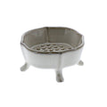 The HomArt Ceramic Rue Footed Soap Dish - Fancy White features four short legs and a raised, perforated platform for drainage—a stylish accessory that keeps your soap dry.
