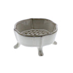 The HomArt Ceramic Rue Footed Soap Dish - Fancy White features four short legs and a raised, perforated platform for drainage—a stylish accessory that keeps your soap dry.