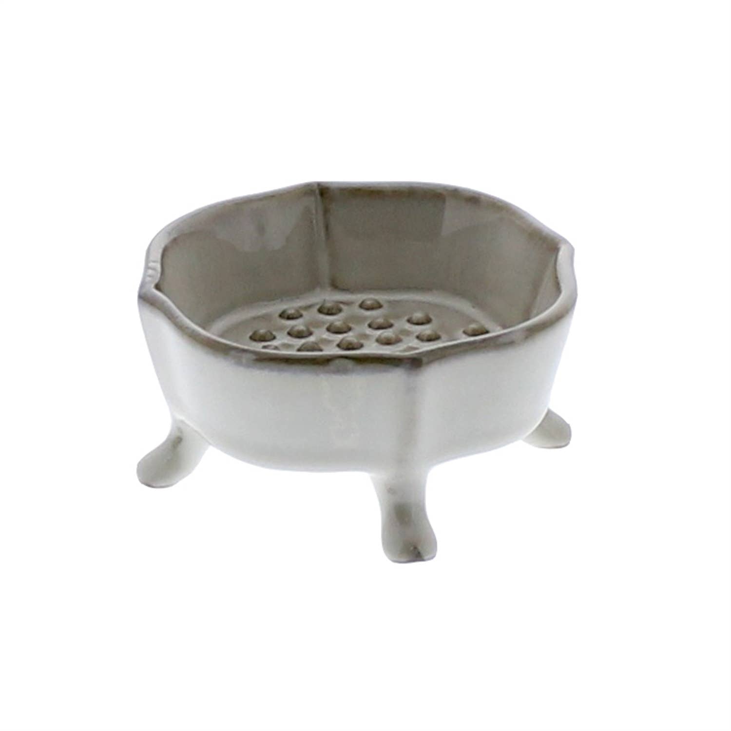 The HomArt Ceramic Rue Footed Soap Dish - Fancy White features four short legs and a raised, perforated platform for drainage—a stylish accessory that keeps your soap dry.