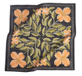The No. 046 Amy Bandana by Handker Bandanas is a square black cotton scarf, hand screen-printed with large orange dogwood flowers, green leaves, and small white dots in a decorative symmetrical design. The fabric has a slightly wrinkled look.