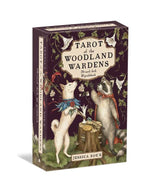 The Tarot of the Woodland Wardens by Jessica Roux (Simon & Schuster) features a beautifully illustrated box depicting an upright dog and a badger encircled by flowers and leaves, with a bird perched on a branch—a gorgeously nature-themed mixed media tarot set with 224 pages, presented in English.