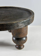 Close-up of the 14in Wide Banjara Reclaimed Look Deep Brown/Black Rugged Wood Stand by Jamali Garden, featuring a thick round tabletop and turned leg—ideal for displaying a mango wood tray against a light background.