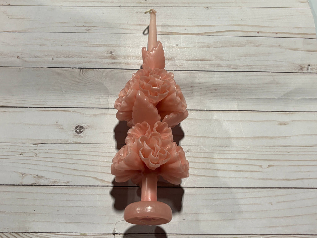 A pale pink handmade Rose Quartz Large Oaxaca Marigold Candle sculpted into the shape of two stacked marigold flowers.