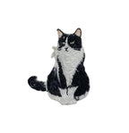 The Tuxedo Cat Iron on Patch by Wholesale Applique features a detailed black and white sitting kitten with green eyes, curled tail, and textured fur, against a white background—perfect for pet lovers.