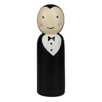 The HomArt Wood Vampire is a hand painted, carved wood peg doll with fangs, rosy cheeks, and a widow's peak. Dressed in a black suit and bow tie, it's perfect as charming Halloween decor.