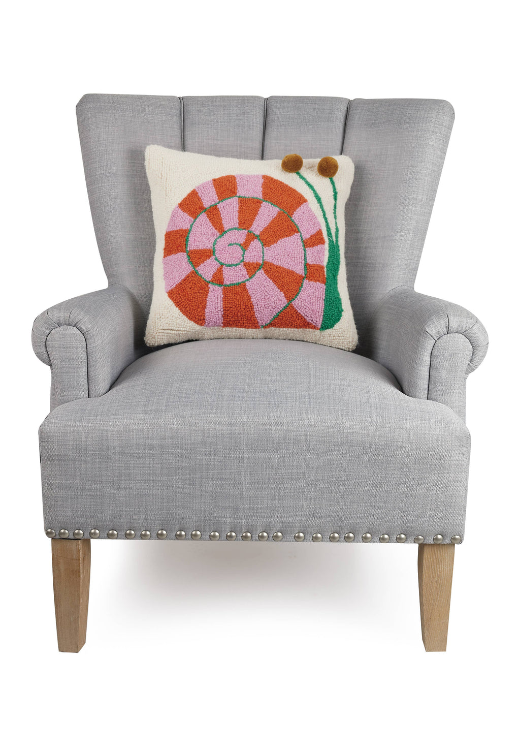 A grey chair featuring the Snail's Pace w/Pom Pom Eyes Hook Pillow by Elizabeth Olwen for Peking Handicraft.