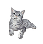 The Gray Tabby Cat Iron on Patch by Wholesale Applique features a lying gray tabby kitten with green eyes, perfect for customizing jackets or bags. Ideal for cat lovers and pet-themed projects.