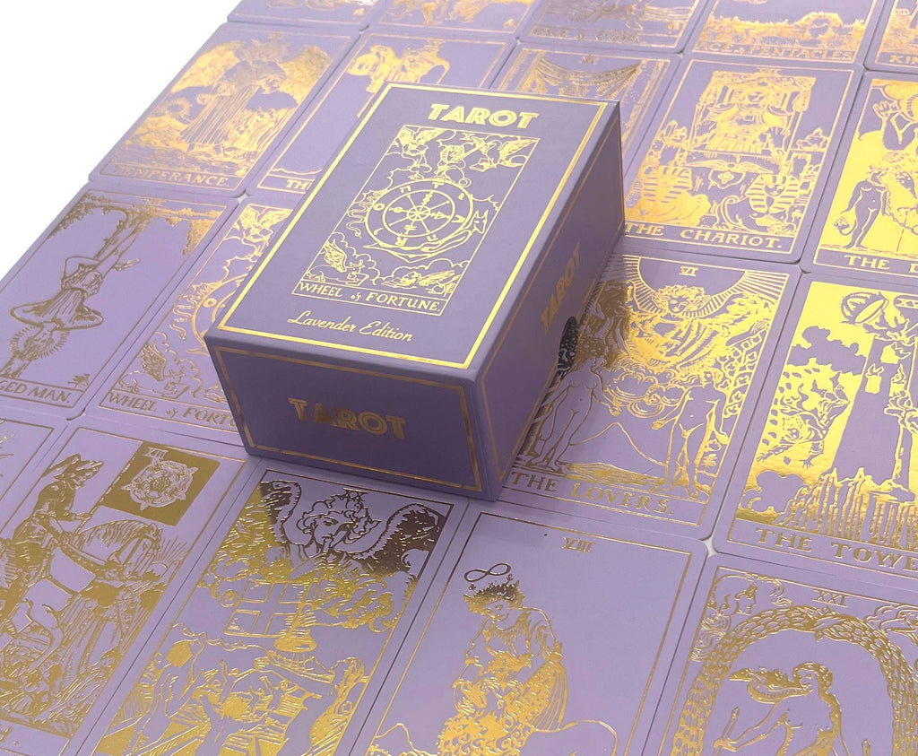 A purple box labeled “Lavender Gold Foil Tarot & Guide | Classic Tarot Design” by Vieux Monde rests on matching gold-accented tarot cards, inspired by Rider-Waite and includes a helpful guidebook.